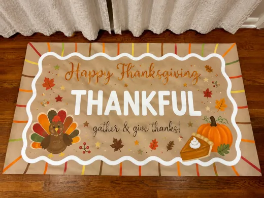 Hand-painted seasonal holiday banner on kraft paper with festive painted details